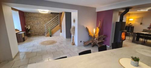 a living room with a staircase and a dining room at Gite Le Tamaris in Mantry