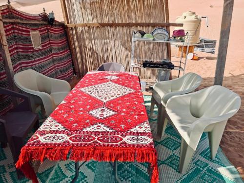 a table with a red and white table cloth on it at ESCAPE cAMp2 in Bidiyah