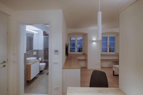 een badkamer met wastafel en toilet in een kamer bij ADAM Suites - Brixen Card included in Bressanone