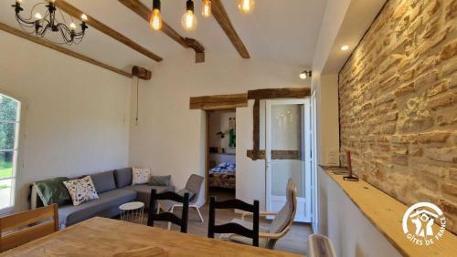 a living room with a couch and a table at Le chinchilla in Gaillac