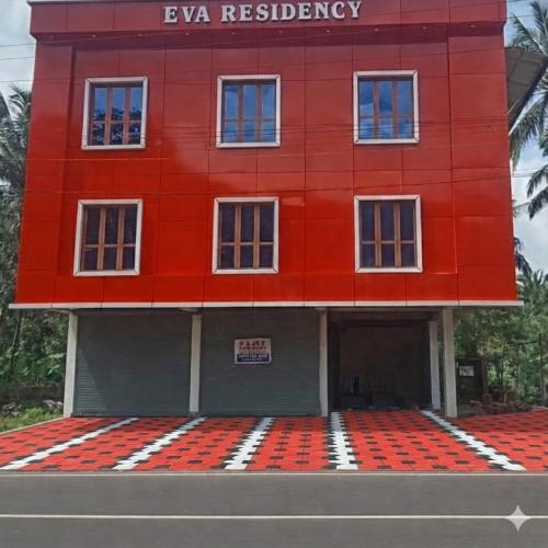 a red building on the side of a road at EVA Residency in Kallar