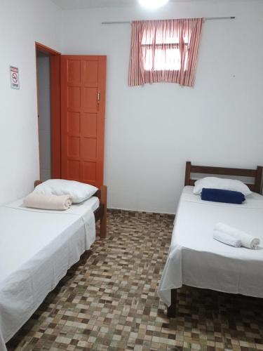 En eller flere senge i et værelse på Pousadinha encantos