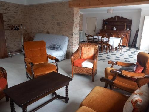 a living room filled with furniture and a dining room at Trivalou in Fauch