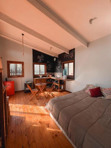 a bedroom with a bed and a desk in it at Tiny House Al lado del río in Linares