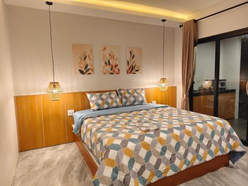 a bedroom with a bed with two lights on it at Ingtara at Lanta in Ko Lanta