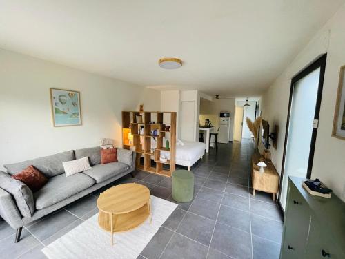 a living room with a couch and a table at Les pieds dans l'eau in Thonon-les-Bains