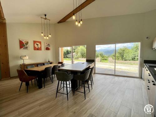 a kitchen and dining room with a table and chairs at Gite du tatou in Roquefeuil