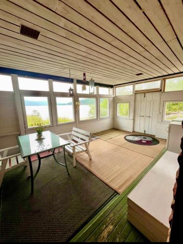 a large room with a table and a bench at Villa Lakeside in Utsjoki