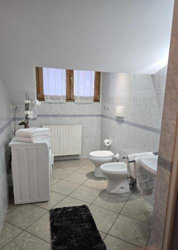 a bathroom with two toilets and a sink at Mely House centralissimo in Castel di Sangro