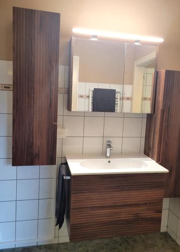 a bathroom with a sink and a mirror at La Friandise in Seppois-le-Bas