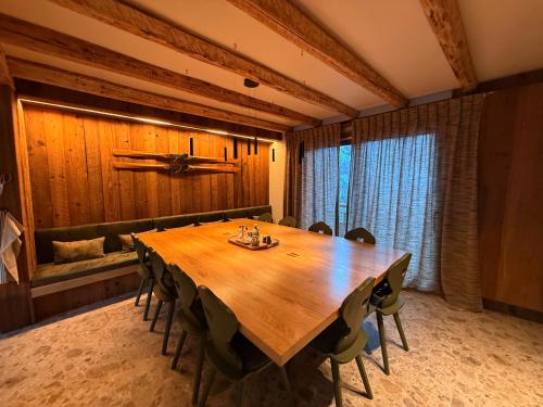 a dining room with a wooden table and chairs at Chalet Oslo by Lodji in Saint-Marcel