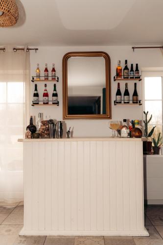 a mirror above a white counter in a room at Maison Le Catelier in Le Catelier