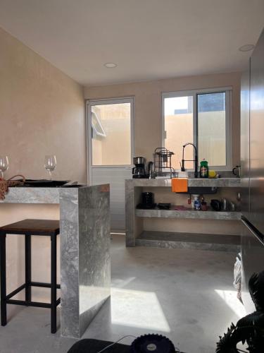 a kitchen with a counter and a table in it at La Belle Dojo in Chelem