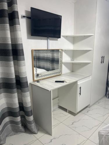 a white desk with a television on top of it at 85 Hidden Gem in Newlands