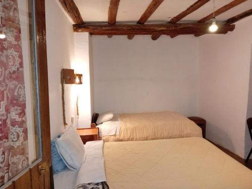 En eller flere senge i et værelse på Casa Cusco guest house