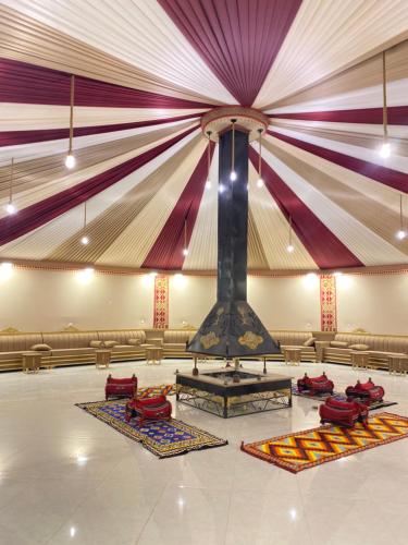 a large room with a large ceiling with a stage at Wadi Rum Alia Luxury Camp in Wadi Rum