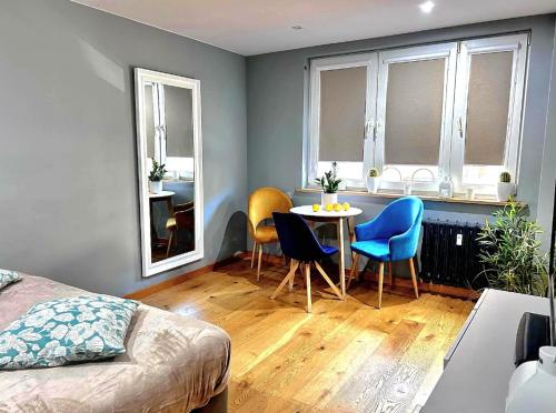 a bedroom with a table and chairs in a room at Apartament Pastelowy Tukan in Kwidzyn