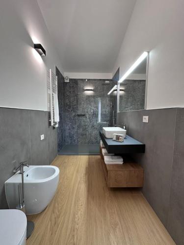 a bathroom with a white tub and a sink at Mediterranea Apartments Sunrise in Assemini