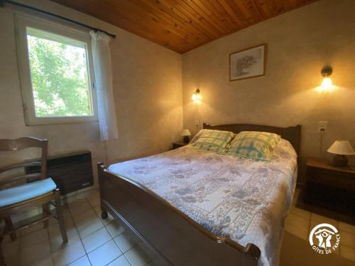 een slaapkamer met een bed in een kamer met een raam bij Mas garrigole in Eus