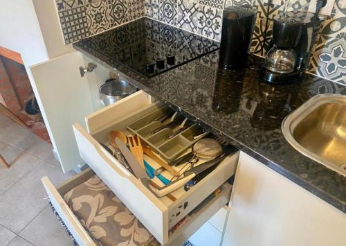 a drawer in a kitchen with utensils in it at CASA DO PENEDO - Um Segredo na Serra da Estrela in Linhares