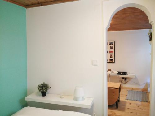 a bedroom with a white bed and a desk at Rosinha 82 Apartment in Lisbon