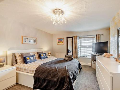 a bedroom with a bed and a flat screen tv at 2 Bed in Seahouses oc-cn082 in Seahouses