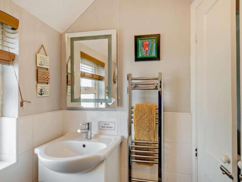 a bathroom with a sink and a mirror at 2 Bed in Seahouses oc-cn082 in Seahouses