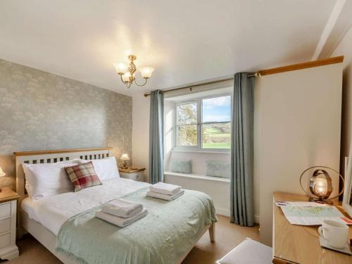 a bedroom with a bed with towels on it at 2 Bed in Ambleside oc-89748 in Hawkshead
