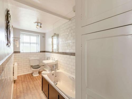a bathroom with a tub and a sink and a toilet at 2 Bed in Ambleside oc-89748 in Hawkshead