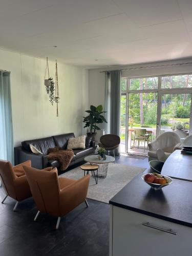 a living room with a couch and a table at Natuurhuisje Pine & Oak 6 persoons in Hardenberg