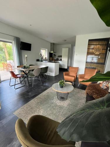 a living room with a couch and a table at Natuurhuisje Pine & Oak 6 persoons in Hardenberg