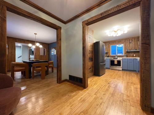 a kitchen and dining room with a table and a refrigerator at Powderhorn Hideaway in Auvinen Corner