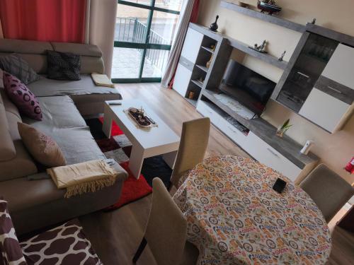 a living room with a couch and a table at A Slice of Paradise - Palheiro Golf in Funchal