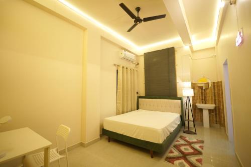 a bedroom with a bed and a ceiling fan at Buddha Premium Stays in Guwahati