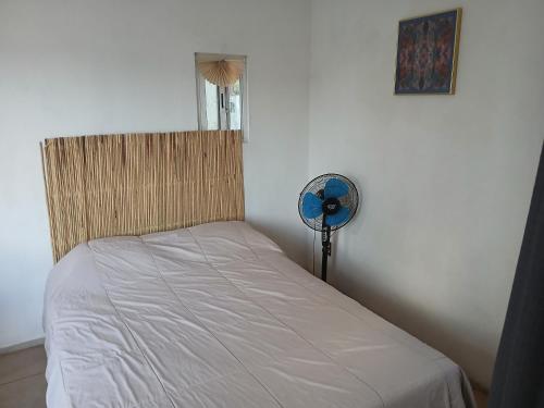 a bedroom with a bed with a fan and a window at Habitación en barrio de Jalatlaco in Oaxaca City