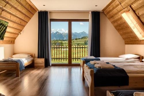 En eller flere senge i et værelse på Willa u Polczyków