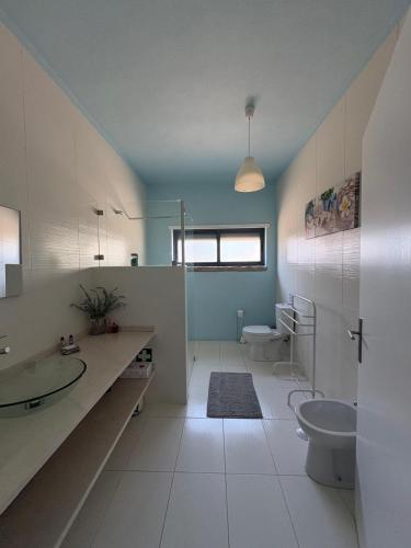 a bathroom with two toilets and a sink and a toilet istg at Refúgio da Serra - Cottage House in Fornos de Algodres