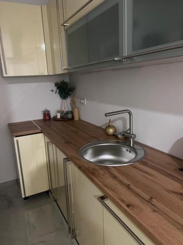 a kitchen with a sink and a wooden counter top at Stan na dan Ana in Prozor