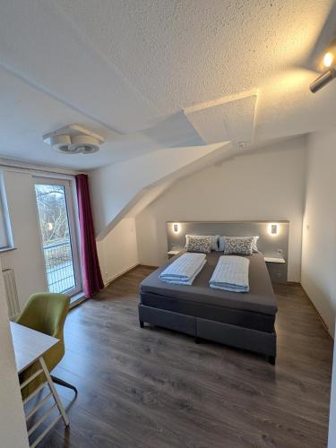 a bedroom with a bed and a table and a window at Air 41 in Konstanz
