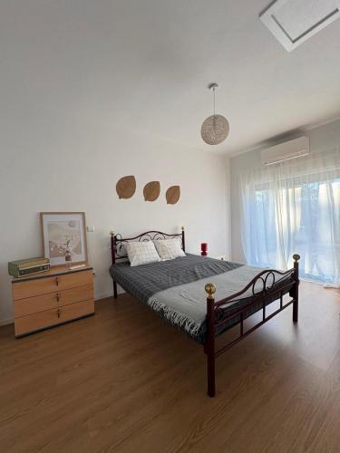 a bedroom with a bed and a dresser in it at Refúgio da Serra - Cottage House in Fornos de Algodres
