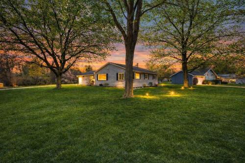 a house in a yard with trees in the grass at Minutes to Notre Dame - The Light on Brighton in South Bend