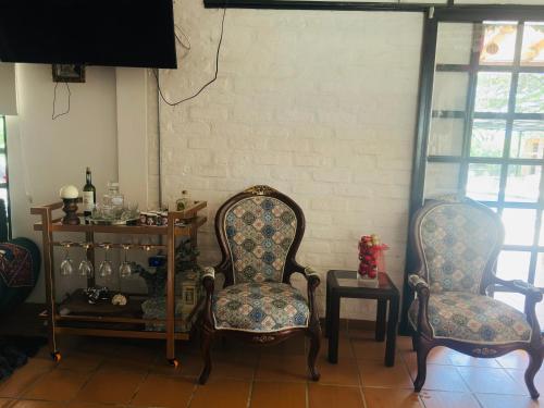 two chairs sitting in a room with a table at Finca el origen 2025 in Roldanillo