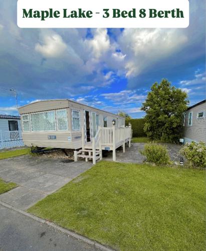 a mobile house with a porch in a yard at Southview Holiday Park in Winthorpe