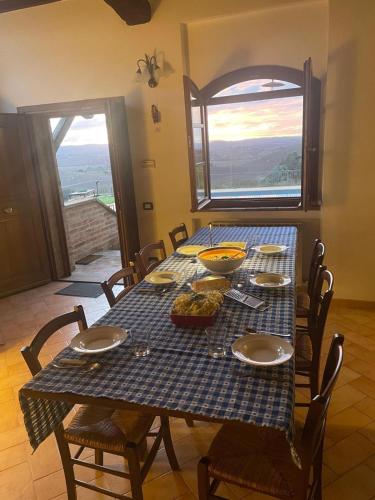 a table with a blue checkered table cloth with food on it at Podere Stabbia in Rosennano