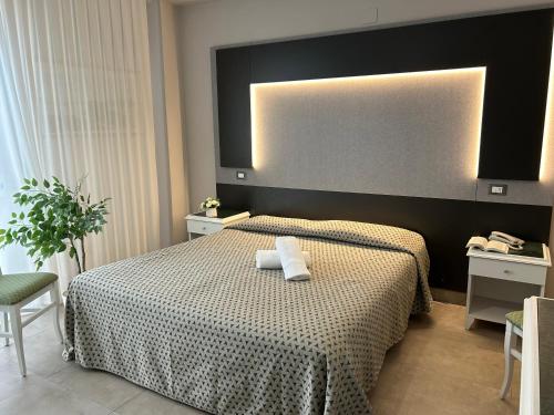a bedroom with a bed with two towels on it at Grand Eurhotel in Montesilvano