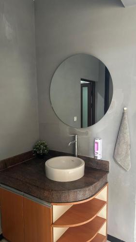 a bathroom with a sink and a mirror at Aby's Guest House in Tlekung