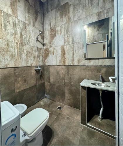 a bathroom with a toilet and a sink at Sueños de Mar in Mar del Tuyú