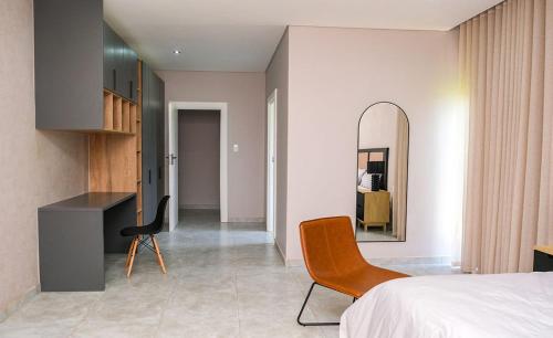 En eller flere senge i et værelse på Mupauli Boutique Lodge