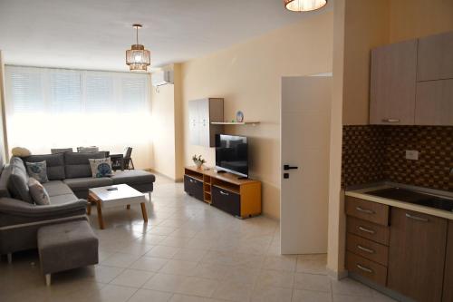 a kitchen and living room with a couch and a table at Coastal Calm in Golem