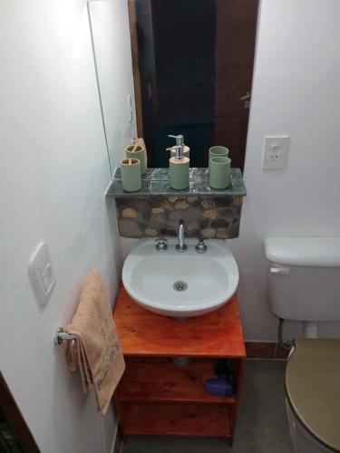 a bathroom with a sink and a toilet at Alojamiento La Oti in Tilcara